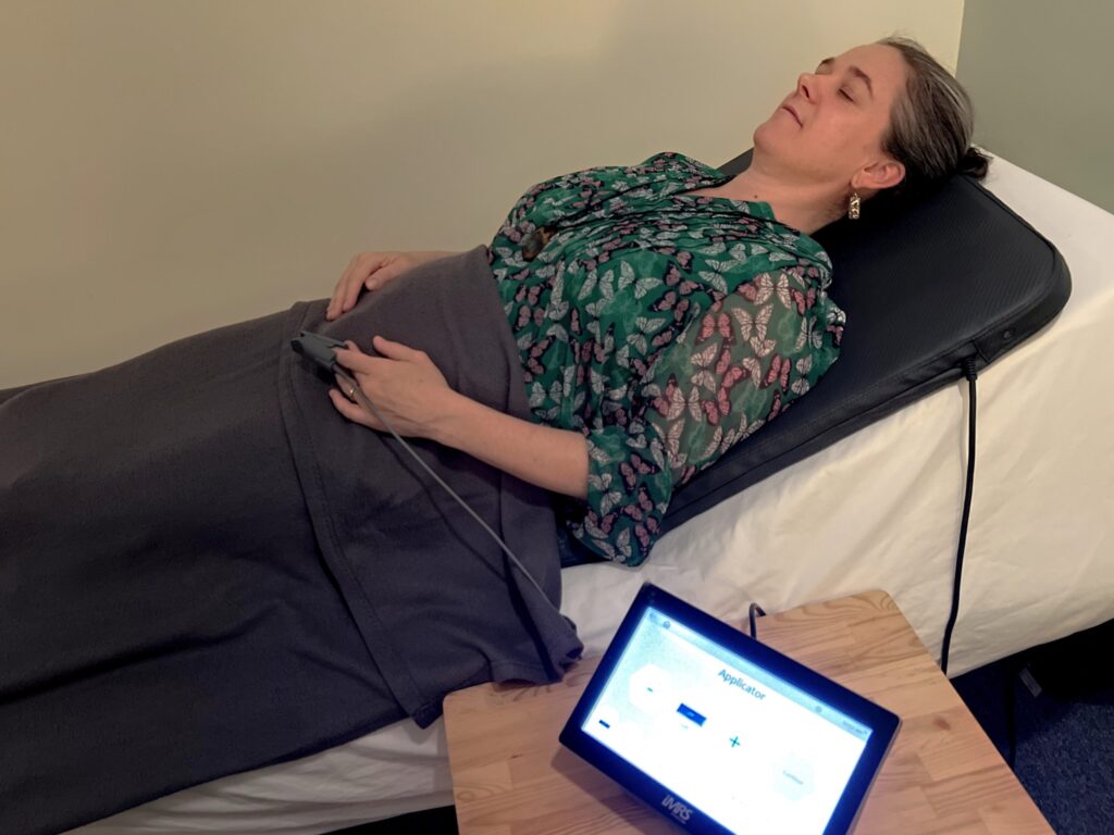 client laying down on PEMF mat