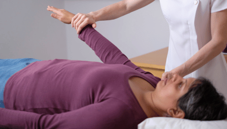 Energy kinesiology practitioner performing muscle testing