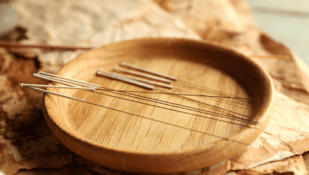 A peaceful acupuncture session at The Teal Center in Arlington, VA, showing a close-up of a wooden tray of acupuncture needles